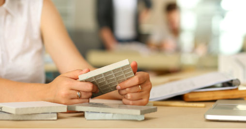 A woman looking at a variety of tile samples.