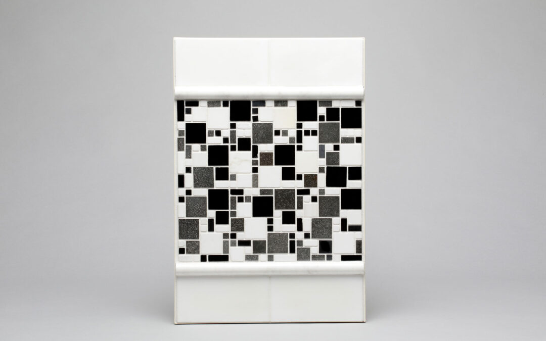 A grouted tile backsplash sample board created by Sampco.